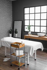 Interior of spa salon with couch, tables and mirror