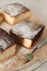 Grid with pieces of cottage cheese casserole on table, closeup