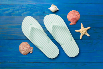 Striped flip flops on wooden background, top view