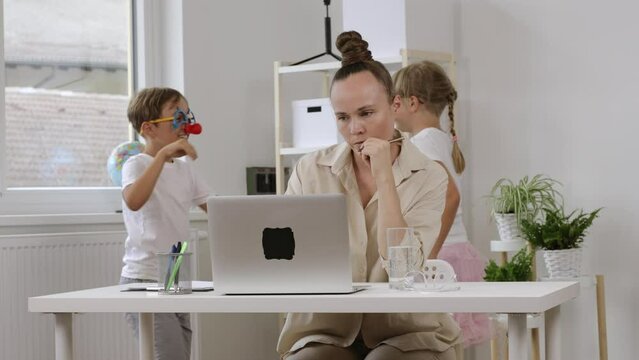 Young Mother Is Working At Laptop. Homeoffice