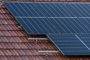 High efficiency half cell solar panels at the top of a family house - 567546860