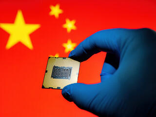 Computer chip microprocessor in the lab glove against China Flag as ideas concept for modern...