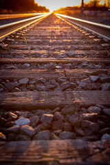 middle of a railroad track looking down the tracks at sunset 