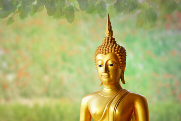 Makha Asanaha Visakha Bucha Day Golden Buddha image. Background of Bodhi leaves with shining light. Soft image and smooth focus style