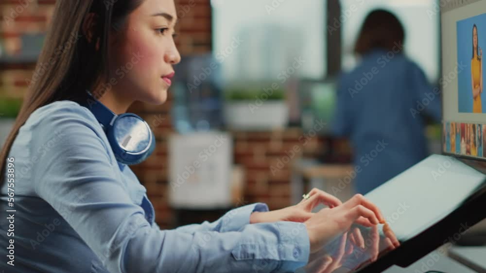 Aufkleber asian woman working as editor with graphic tablet and stylus, using photo editing software to fix co