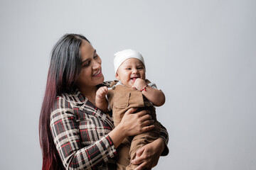 Mother and her baby very happy with her. Young mother holding her baby. Latin American mom with her...