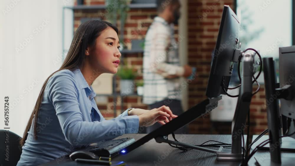 Poster asian female engineer using touchscreen display to create game interface on professional software. c