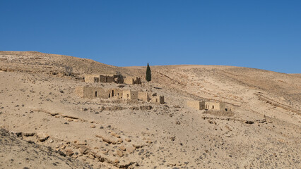 Ruins of houses from historic earthquake in baron desert hills landscape at Shobak Castle in Jordan, Middle East 