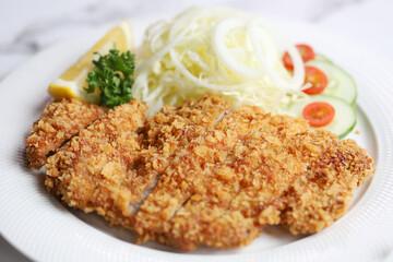 Pork tonkatsu served with lettuce And delicious gravy Is a national food that is good for health, Pork tonkatsu