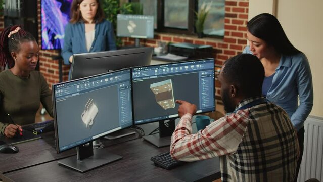 Creative 3d engineers designing mechanical clamp on manufacturing cad software, using 3d render interface. Young technicians working on industrial product asset, machinery production.