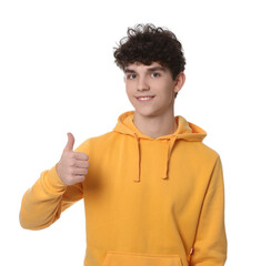 Portrait of smiling teenage boy showing thumb up on white background