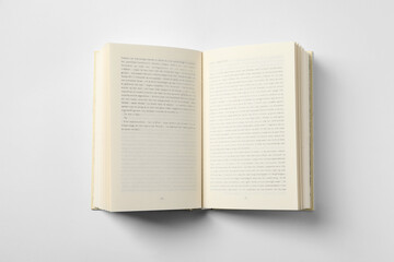 Open book on white background, top view - obrazy, fototapety, plakaty