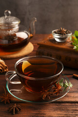 Aromatic tea with anise stars and mint on wooden table