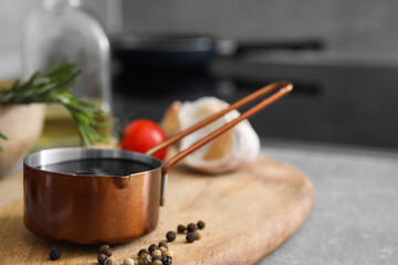 Organic balsamic vinegar and cooking ingredients on grey table. Space for text