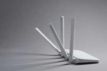 New stylish Wi-Fi router on grey background. Space for text