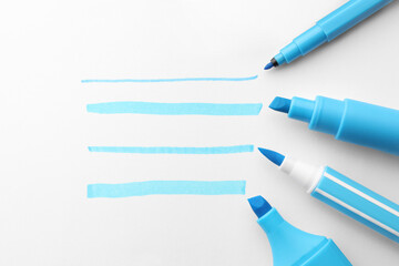 Light blue stripes drawn with markers and highlighters isolated on white, top view