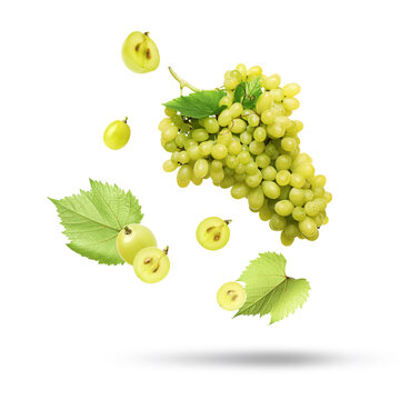 Delicious fresh grapes and leaves falling on white background