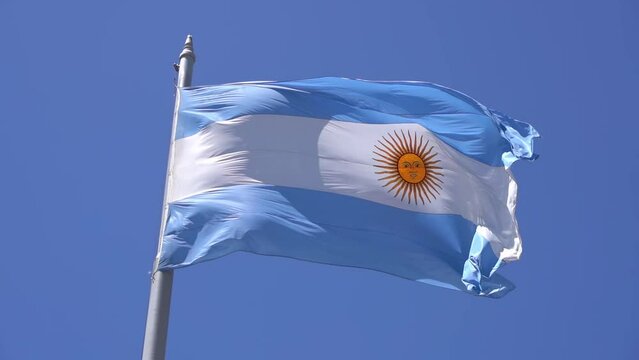 Argentinean flag against the blue sky in Buenos Ares. The national blue and white flag of Argentina.
