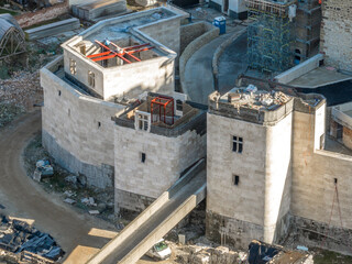 Closeup aerial view of two twin square gate towers being restored in medieval Diosgyor castle in Miskolc Hungary