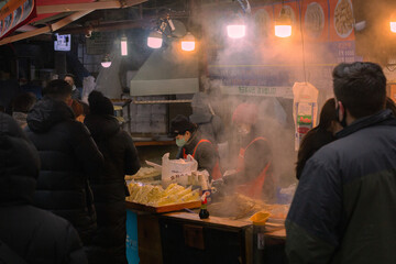 People cooking street market food at Namsung Markets, Seoul, Korea