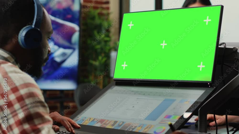 Poster male employee working with greenscreen and retouching software, looking at isolated mockup template 