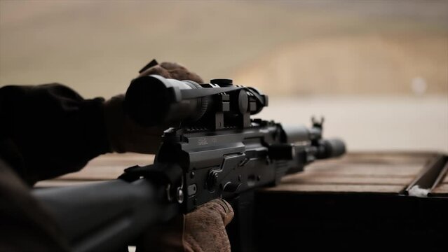 sniper shoots a rifle at war