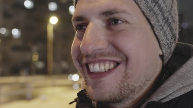 Happy positive young male with wide smile in closeup mumbling something