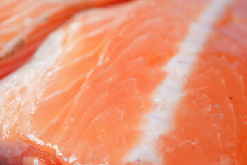 Raw, fresh salmon steak on a plastic packet on table 