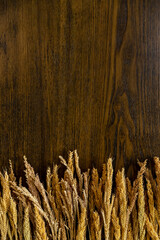 Wooden background along the edge with cereals. Decorations for background.