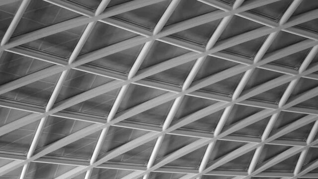 Black And White Closeup Of Double-Barrel-Vaulted Glass Ceiling Of King's Cross Railway Station In London, UK. low angle