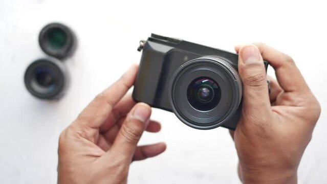 A men is taking pictures on a camera.