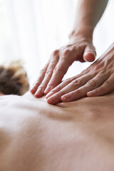 Shiatsu massage on female back. Health, body care, medicine concept. Copy space. Vertical.