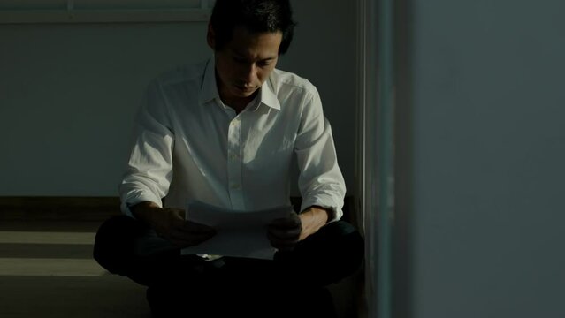 Stressed and headache asian man with large bills or invoices no money to pay to expenses and credit card debt. shortage, Financial problems, mortgage, loan, bankruptcy, bankrupt, poor, empty wallet