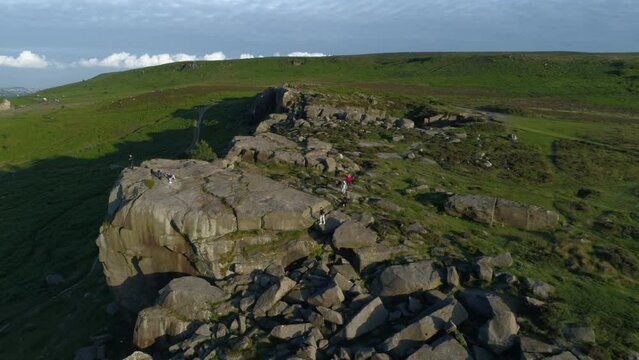Drone Shot Flying Over Cow and Calf Rocks with People Walking on Ilkley Moor West Yorkshire UK