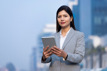 Confident businesswoman using a digital tablet.