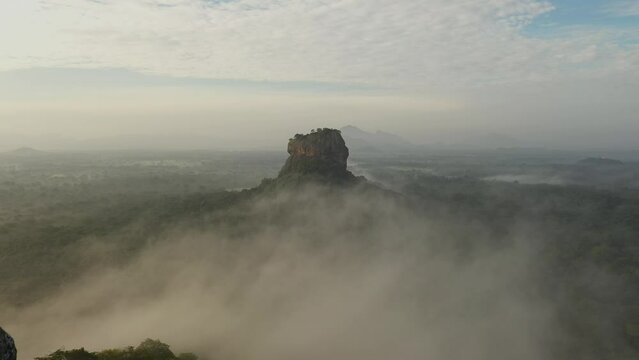 Aerial drone view of Sigiriya rock in Sri Lanka at sunrise. Nature, jungle, clouds 