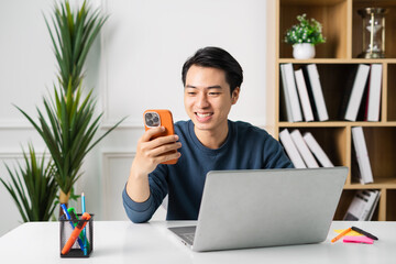 image of Asian man sitting at home working
