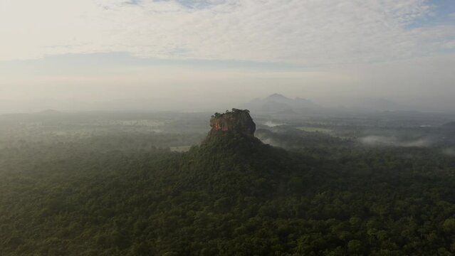 Aerial drone view of Sigiriya rock in Sri Lanka at sunrise. Nature, jungle, clouds 