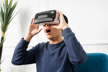 image of asian man wearing virtual reality glasses on purple background