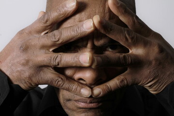 Fototapeta premium man praying to god at home on black background with people stock photo 