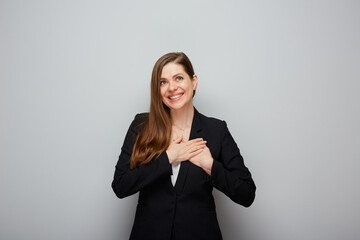 Young smiling business woman holding hands on chest, heart Isolated portrait.