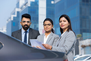 Group of businesspeople going through a report at work