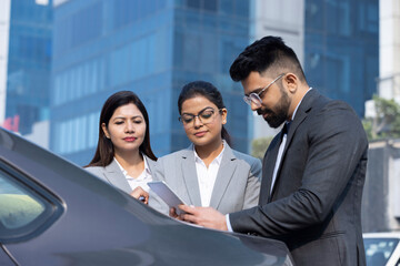 Group of businesspeople going through a report at work