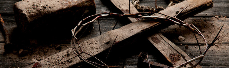 Fototapeta na wymiar Crucifixion At Sunset - Cross With Crown Of Thorns Hammer And Bloody Nails