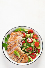 Salad with chicken meat. Fresh vegetable salad with chicken breast. Meat salad with chicken fillet and fresh vegetables on plate.
