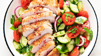 Salad with chicken meat. Fresh vegetable salad with chicken breast. Meat salad with chicken fillet and fresh vegetables on plate.