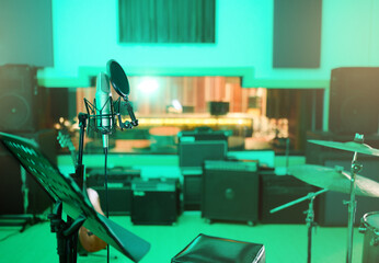 Music, recording studio and interior with instruments for creative, musician or industry background. Audio technology, microphone and sound production for radio, media and electronics in neon lights