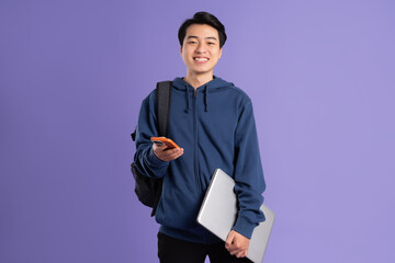 Asian male student portrait on purple background