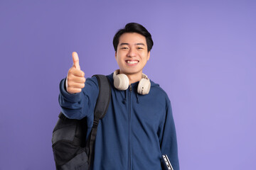 Asian male student portrait on purple background