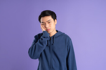 portrait of asian man posing on purple background